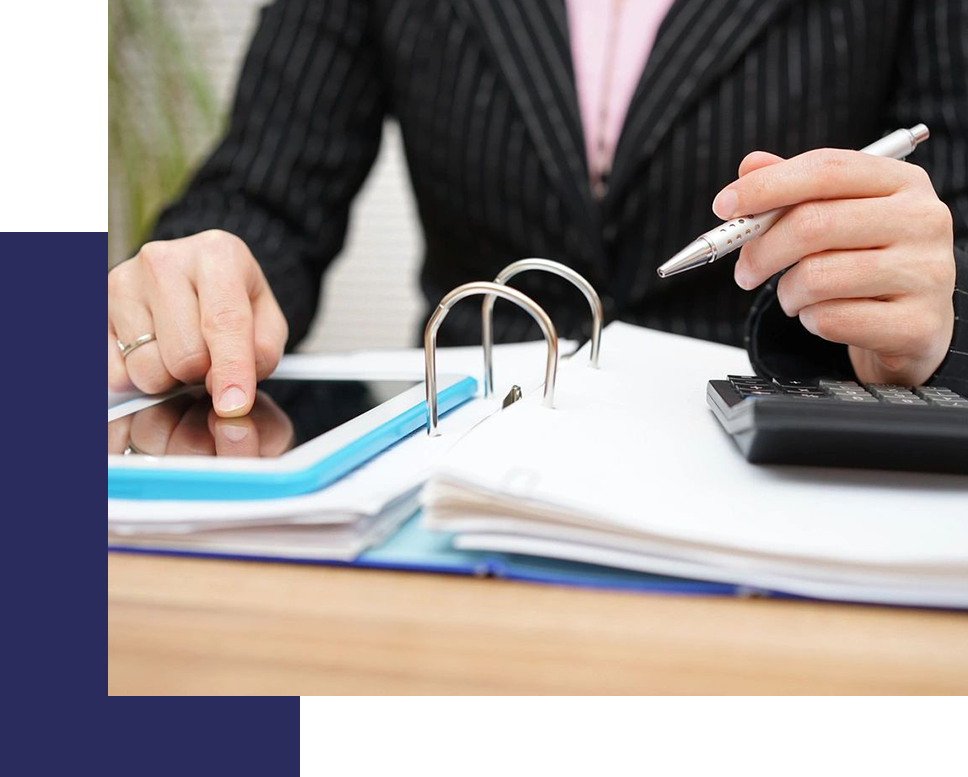 A person sitting at a table with papers and a tablet.